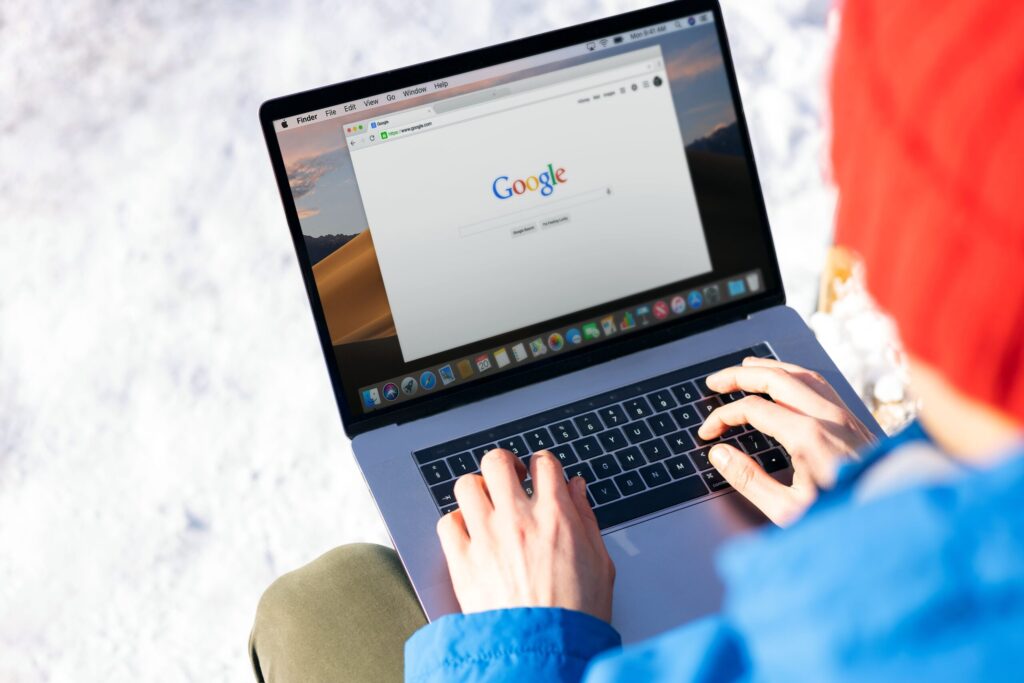 User searching online from a laptop, illustrating the verification of an official domain, website operator, and authorized content source.